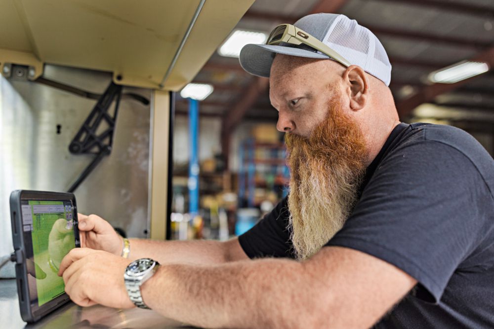 Erik working on a tablet in his shop