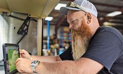 Erik working on a tablet in his shop