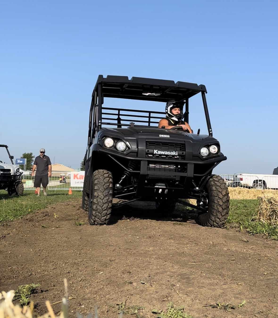 Karen Jones drives a black Kawasaki side by side over an obstacle course at National Farm Machinery Show in Illinois