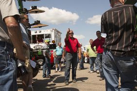 Ring man taking bids at live equipment auction