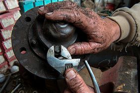 A farmer doing maintenance work.